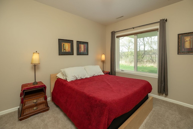 bedroom with carpet floors and baseboards