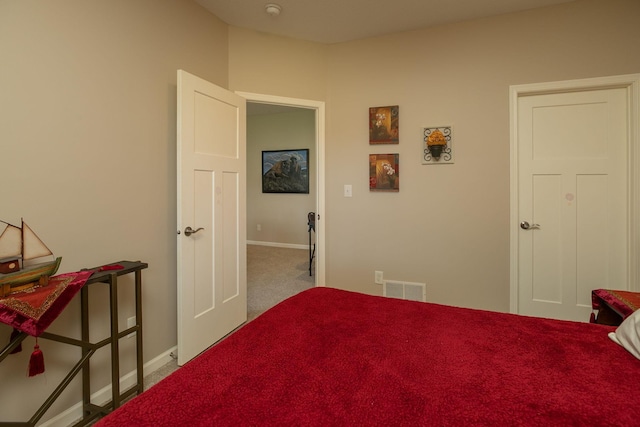bedroom with baseboards, carpet floors, and visible vents