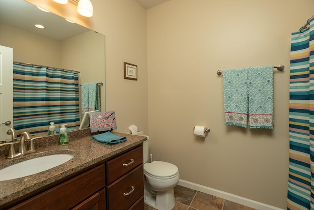 full bathroom featuring vanity, baseboards, and toilet