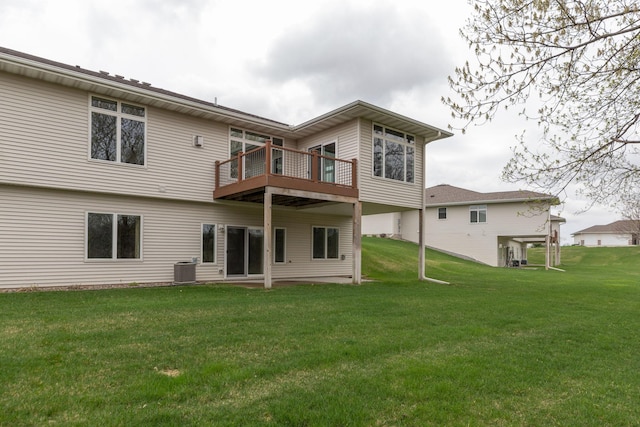 rear view of property featuring central AC unit and a yard
