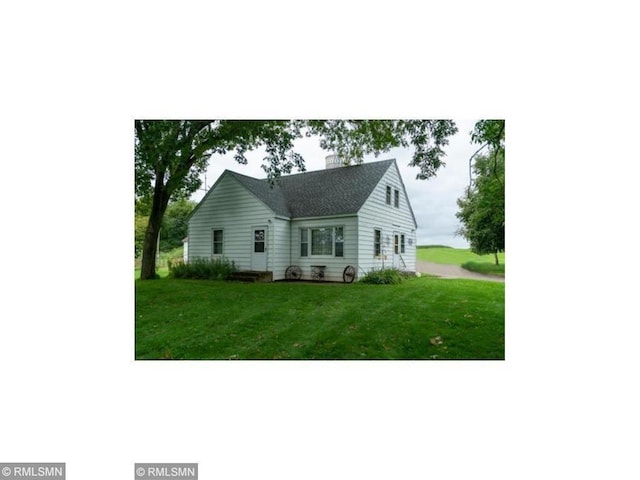 1403 105th Ave, Amery, WI 54001 - view of front facade featuring a chimney and a front yard
