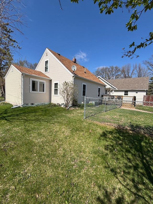back of property with fence and a yard