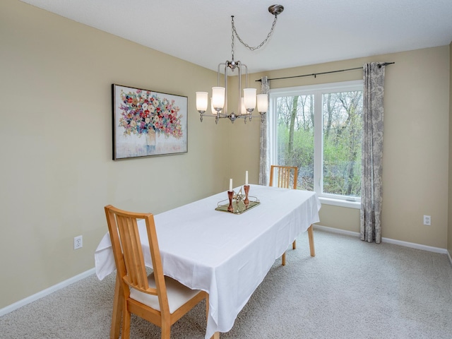dining room with an inviting chandelier, baseboards, and carpet floors