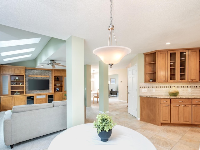 dining room with light tile patterned flooring, a ceiling fan, lofted ceiling with skylight, and recessed lighting