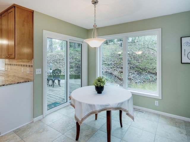 dining room with baseboards, light tile patterned floors, and visible vents