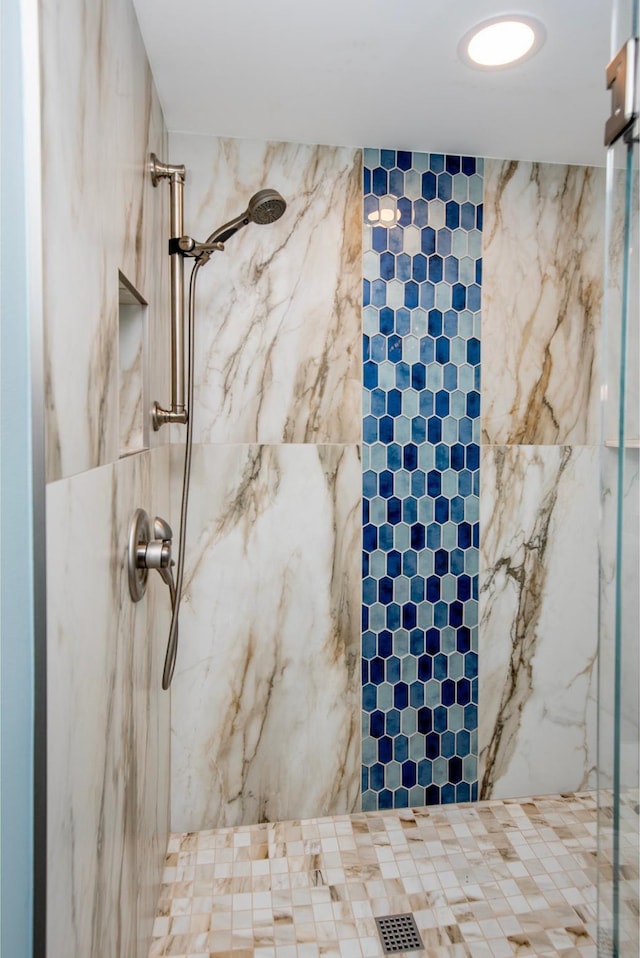 room details featuring a marble finish shower and visible vents