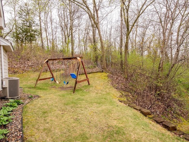 view of yard featuring central AC unit and a playground
