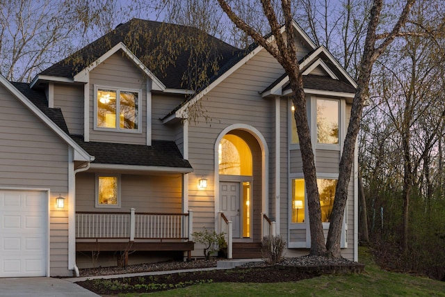 traditional home with a shingled roof and a porch
