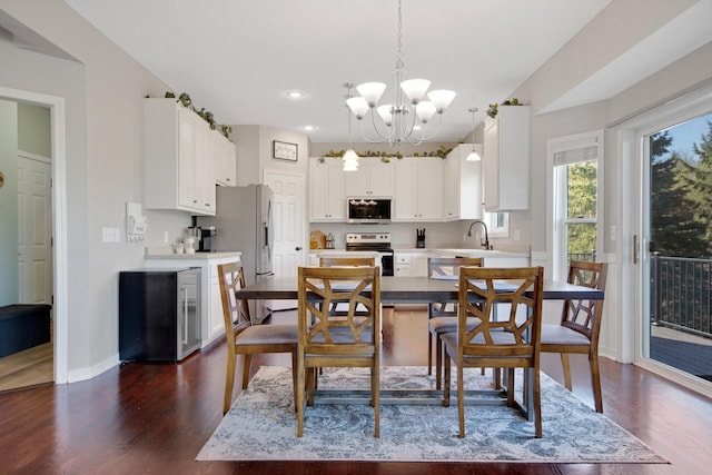 dining room featuring a chandelier, baseboards, dark wood finished floors, and recessed lighting