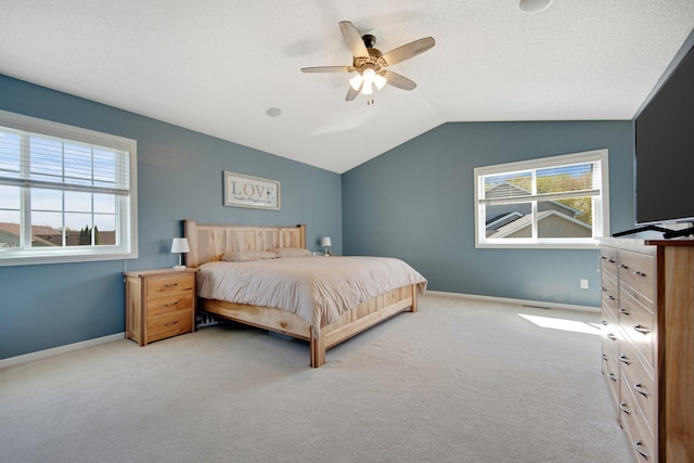 bedroom featuring carpet floors, a ceiling fan, baseboards, and vaulted ceiling