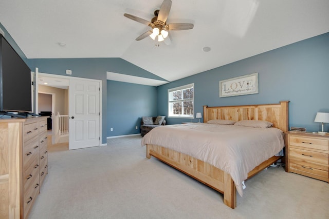 bedroom with baseboards, light carpet, a ceiling fan, and lofted ceiling