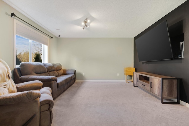 carpeted living area with baseboards and a textured ceiling