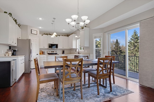dining room with recessed lighting, dark wood finished floors, and an inviting chandelier