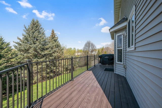 wooden terrace featuring a yard