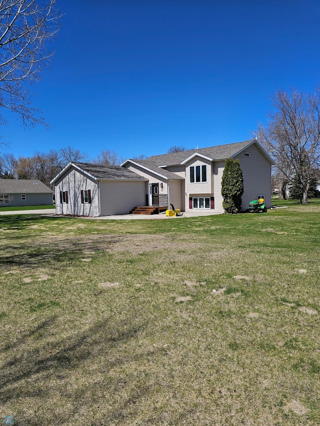 view of front of house with a garage and a front lawn