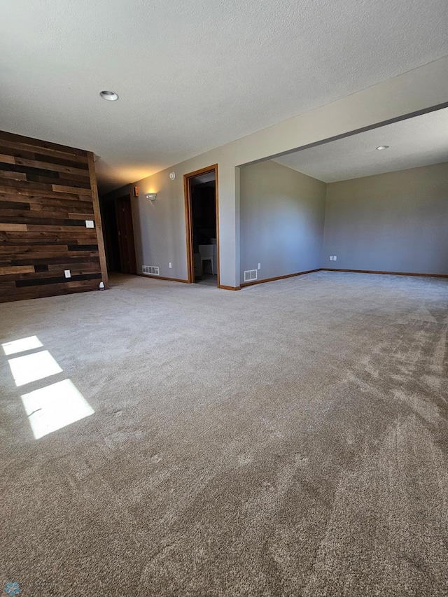 empty room with baseboards, carpet, recessed lighting, and visible vents