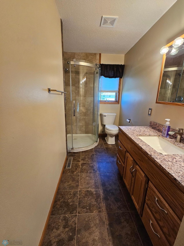 bathroom with visible vents, vanity, toilet, baseboards, and a stall shower
