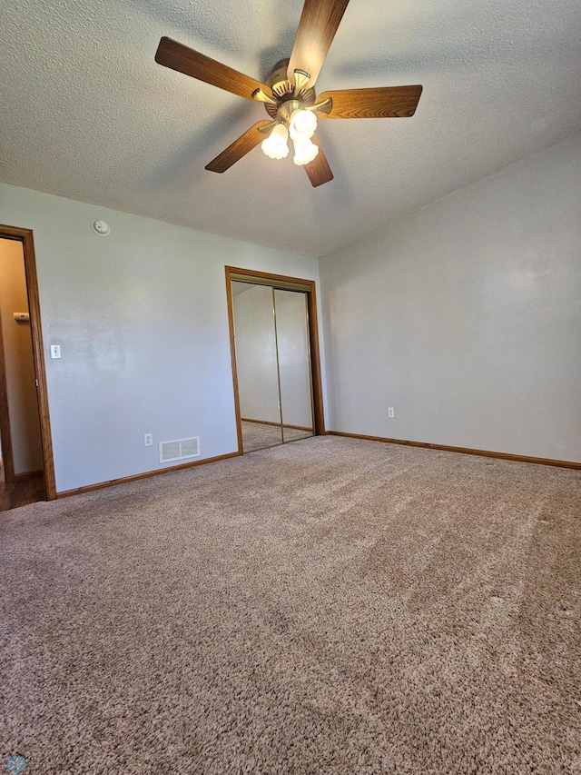 unfurnished bedroom featuring baseboards, carpet flooring, visible vents, and a closet