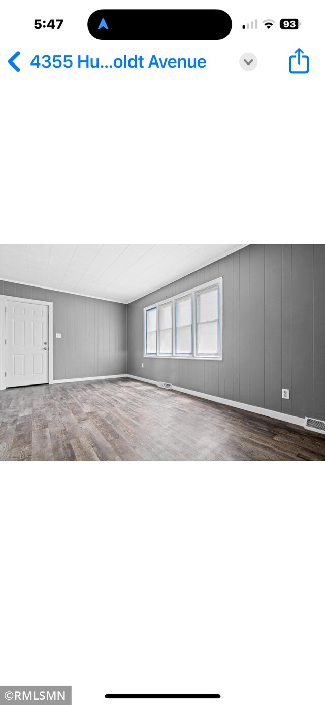 4355 Humboldt Ave N, Minneapolis, MN 55412 - spare room with wood finished floors and a decorative wall