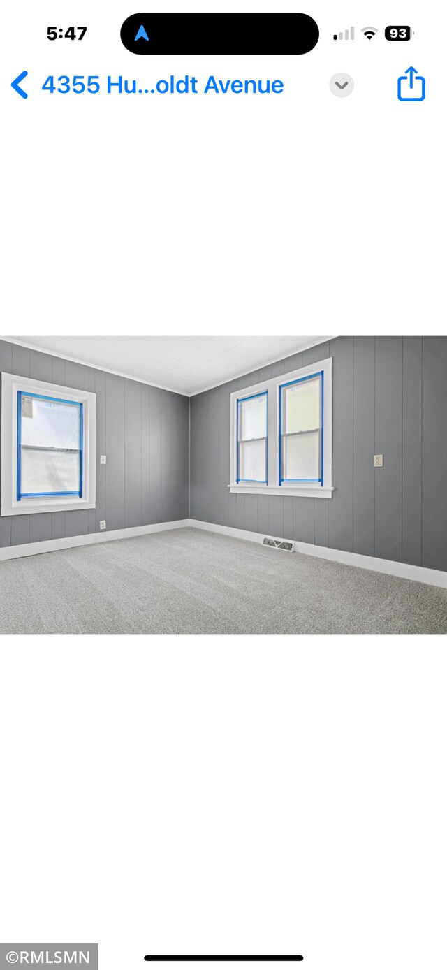 4355 Humboldt Ave N, Minneapolis, MN 55412 - empty room with plenty of natural light, carpet, and a decorative wall
