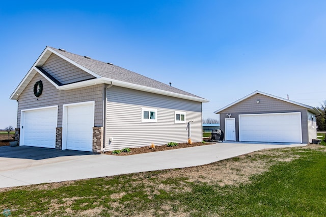 view of home's exterior with an outbuilding and a detached garage