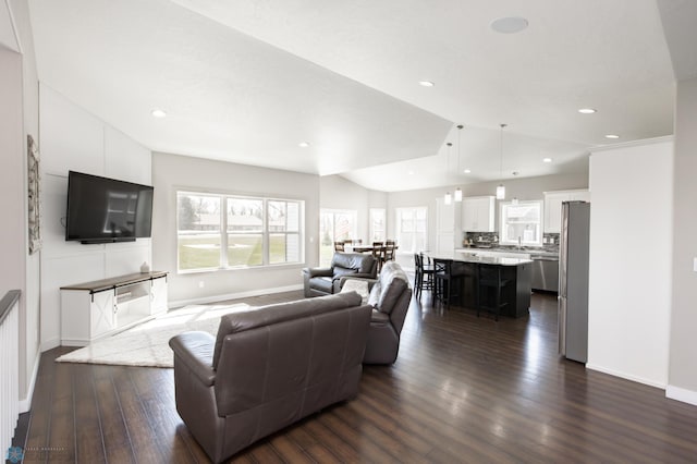 living room with baseboards, vaulted ceiling, recessed lighting, and dark wood-type flooring