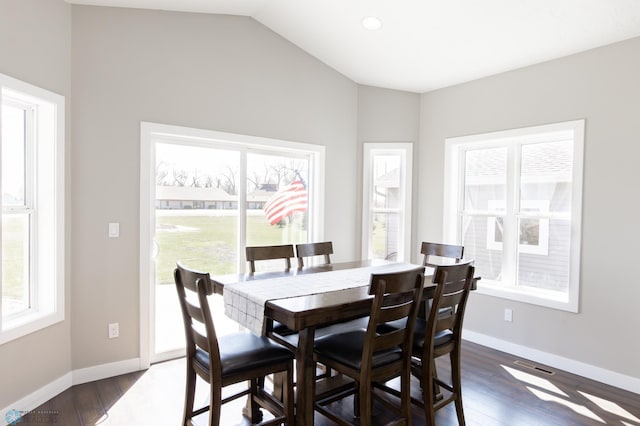 dining area featuring lofted ceiling, baseboards, and dark wood-type flooring