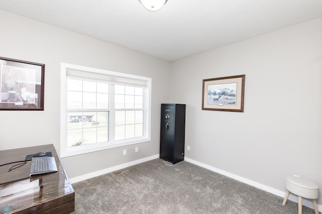 unfurnished office featuring carpet and baseboards