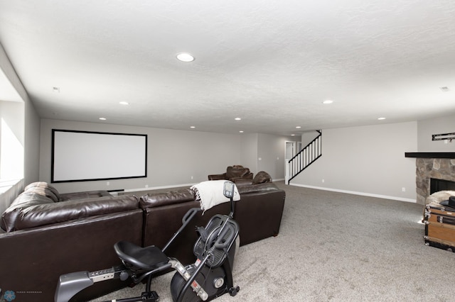 cinema room with carpet flooring, a stone fireplace, recessed lighting, and baseboards