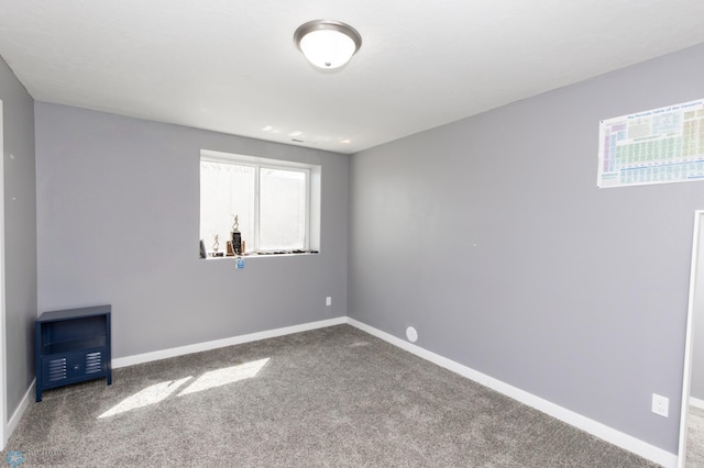 empty room with carpet and baseboards