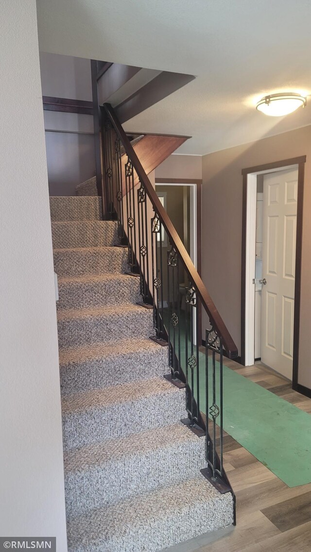 stairs with wood finished floors