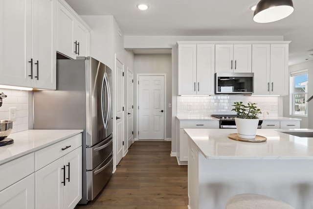 173 Junco Rd N, Lake Elmo, MN 55042 - kitchen with appliances with stainless steel finishes, dark wood-style floors, recessed lighting, white cabinets, and backsplash