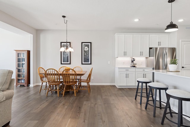 173 Junco Rd N, Lake Elmo, MN 55042 - dining area featuring dark wood finished floors, recessed lighting, baseboards, and a chandelier