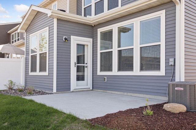 173 Junco Rd N, Lake Elmo, MN 55042 - entrance to property with central AC unit, fence, and a patio