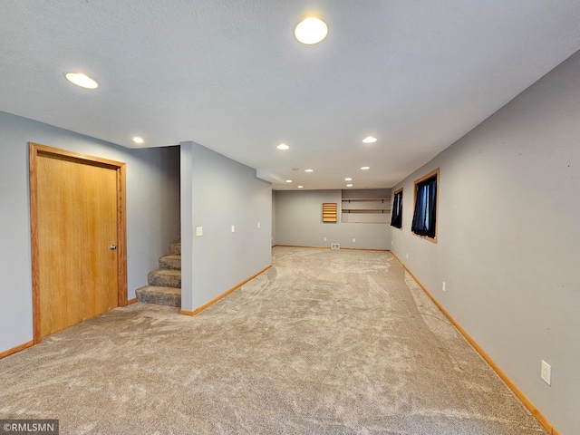 finished basement featuring carpet floors, recessed lighting, and baseboards