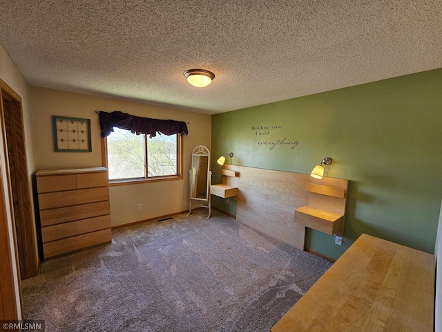 sitting room with baseboards, a textured ceiling, and carpet