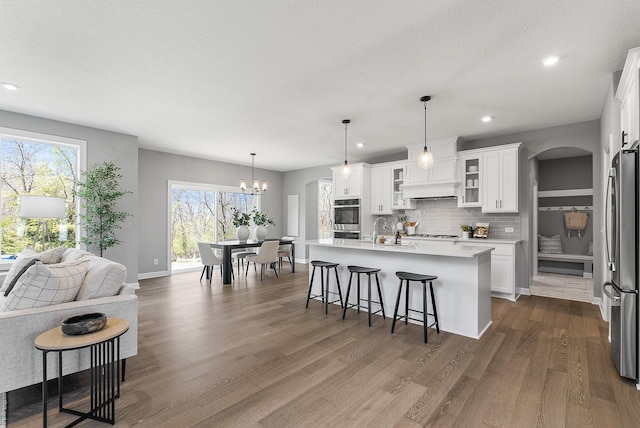 kitchen featuring stainless steel appliances, light countertops, plenty of natural light, backsplash, and recessed lighting