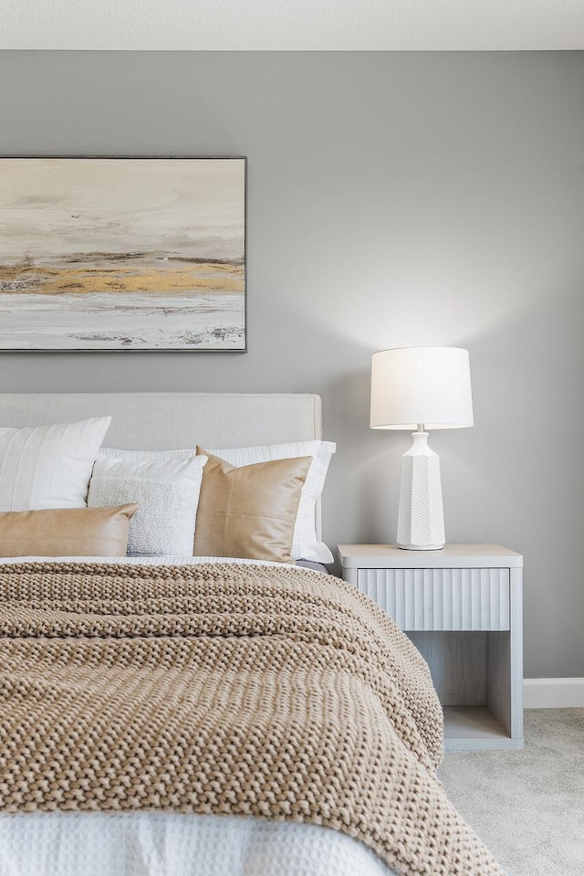 carpeted bedroom featuring baseboards