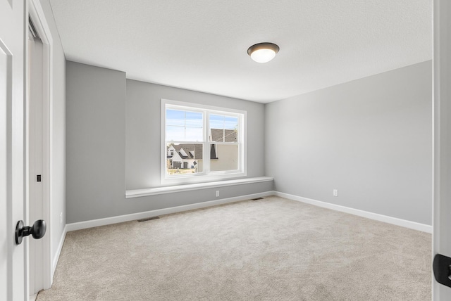 spare room with carpet floors and baseboards