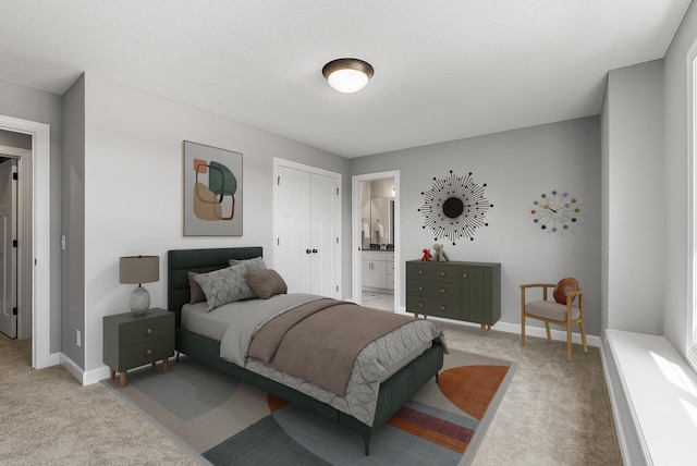bedroom with carpet flooring, baseboards, connected bathroom, and a closet