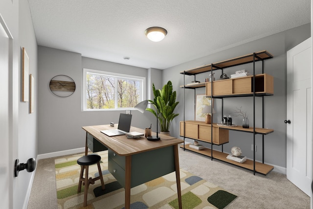 home office featuring carpet, baseboards, and a textured ceiling