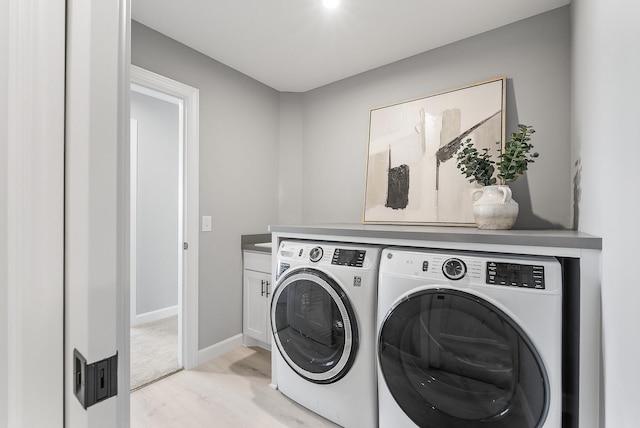 laundry area with washer and clothes dryer, cabinet space, and baseboards