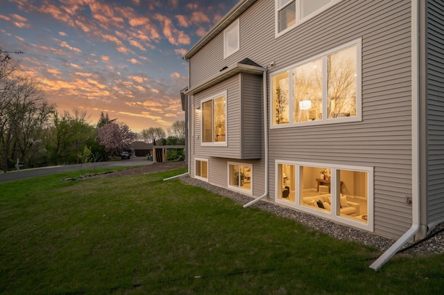 rear view of property featuring a lawn
