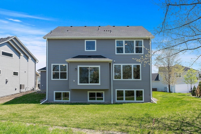 rear view of property with a lawn