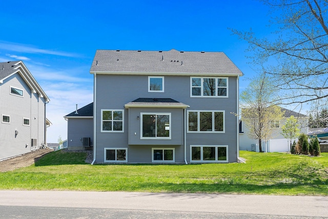 rear view of property with a yard