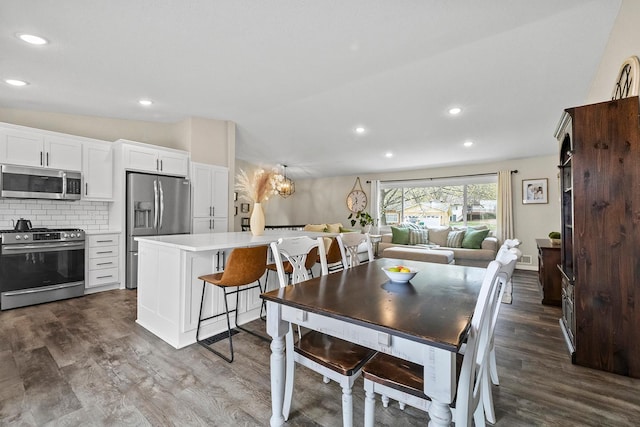 dining area with recessed lighting and dark wood-type flooring