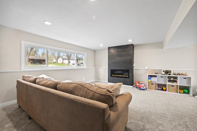 carpeted living room with baseboards, a fireplace, recessed lighting, and a textured ceiling