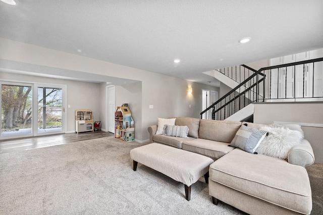living room featuring carpet, stairway, baseboards, and recessed lighting
