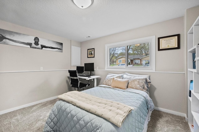 carpeted bedroom featuring a textured ceiling and baseboards