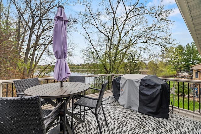 view of patio / terrace with a deck with water view, area for grilling, and outdoor dining area